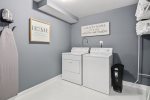 Laundry room hosts the washer & dryer & extra bedding necessities -basement-